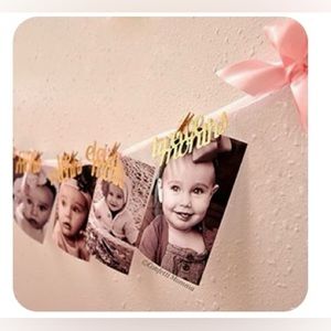First year banner. Gold sparkling word birthday decorations banner pink ribbons